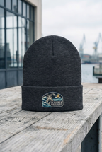 GataKarma Marea Cuffed Beanie, dark grey, on a workbench facing the harbour (2/6) — MAREA collection by BarnaBorders